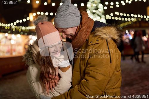 Image of happy young couple with coffee at christmas market