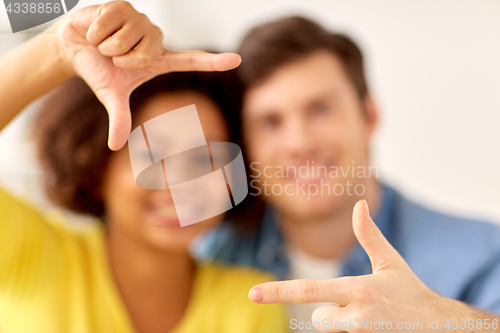 Image of happy couple hands making frame gesture