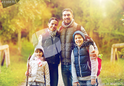 Image of happy family with backpacks hiking