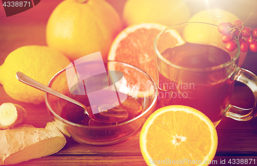 Image of tea with honey, lemon and ginger on wood