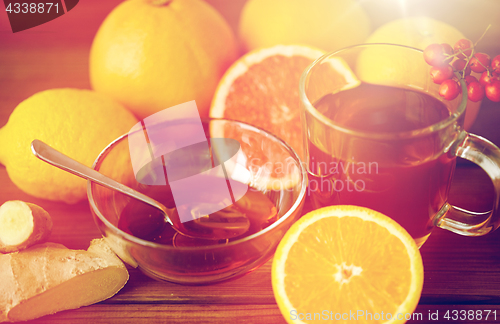 Image of tea with honey, lemon and ginger on wood