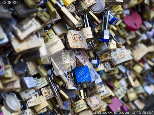 Image of Love locks in Paris bridge symbol of friendship and romance