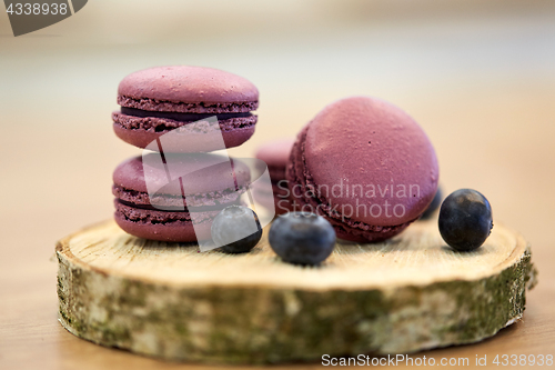 Image of blueberry macarons on wooden stand