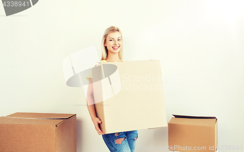 Image of smiling young woman with cardboard box at home