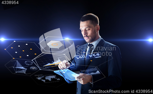 Image of businessman with tablet pc and virtual screens