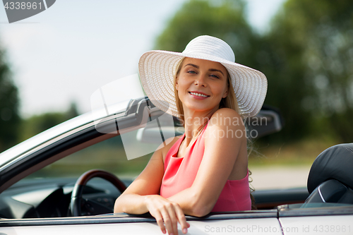 Image of happy young woman in convertible car