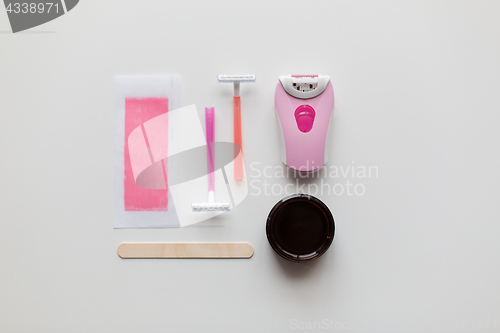 Image of hair removal wax, epilator and safety razor