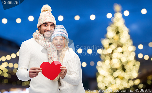 Image of couple with red hearts over christmas lights