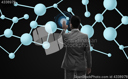 Image of businessman working with molecule formula