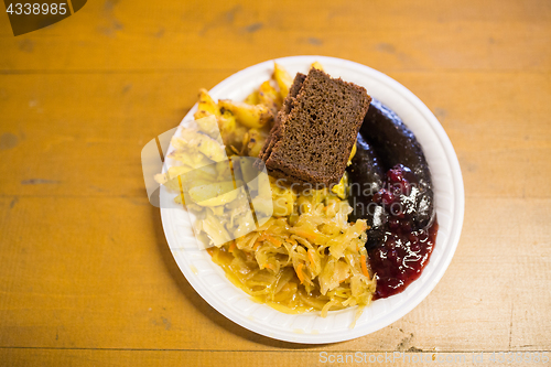 Image of braised cabbage and sausages with sauce on plate