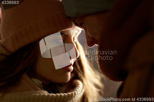 Image of close up of happy couple in winter clothes