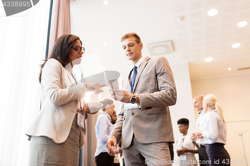 Image of couple with smartphone at business conference