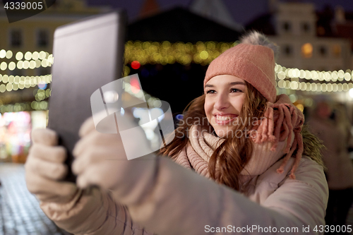 Image of woman with tablet pc at christmas tree outdoors