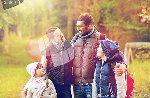 Image of happy family with backpacks hiking