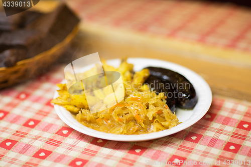 Image of braised cabbage and sausages with sauce on plate