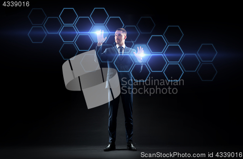 Image of businessman working with virtual network hologram