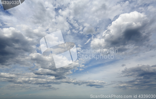 Image of Sheer high cloud mixed with heavy darker clouds with blue sky