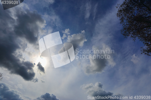 Image of Sun shining through light cloud summer blue sky Australia