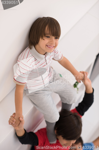 Image of young boys posing line up piggyback top view