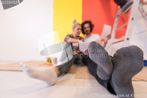 Image of Happy young couple relaxing after painting