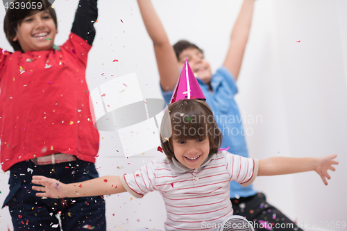 Image of kids  blowing confetti