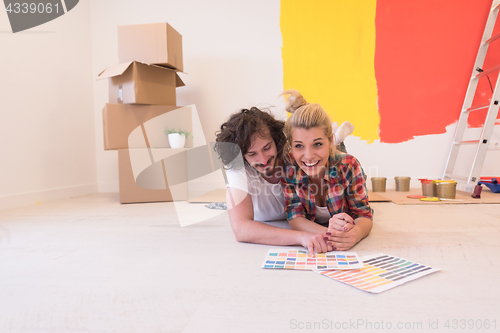 Image of Happy young couple relaxing after painting