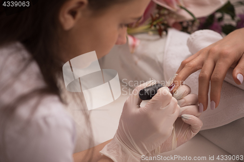 Image of Woman hands receiving a manicure