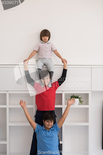 Image of young boys posing line up piggyback