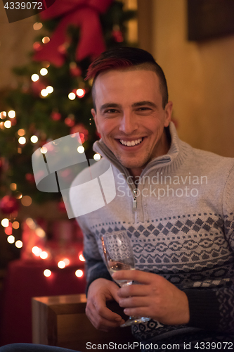 Image of Happy young man with a glass of champagne