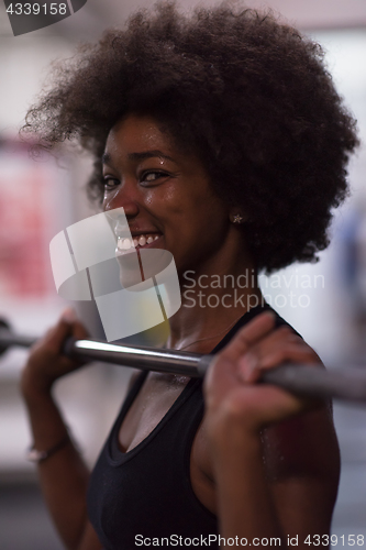 Image of black woman lifting empty bar