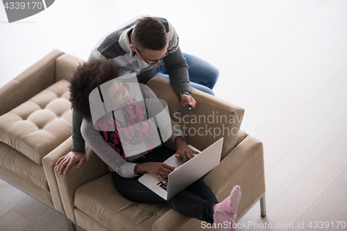 Image of multiethnic couple shopping online