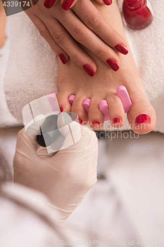 Image of female feet and hands at spa salon