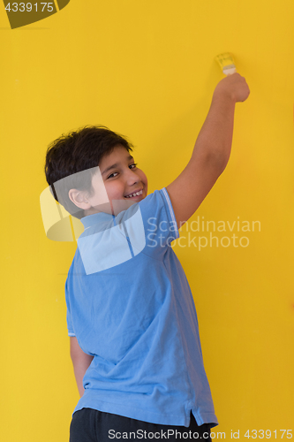 Image of Portrait of a happy young boy painter