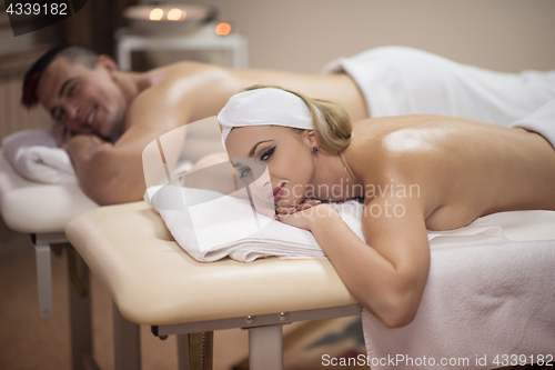 Image of young couple lying on massage table