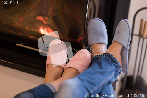 Image of Young couple  in front of fireplace
