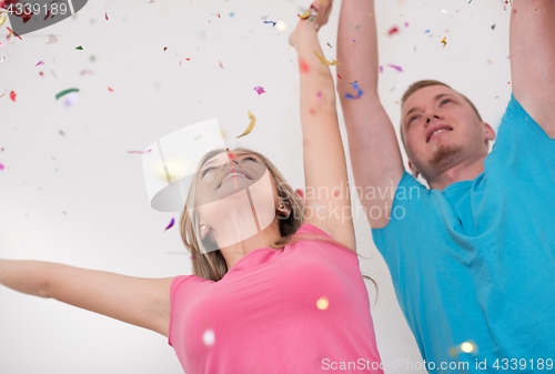 Image of romantic young  couple celebrating  party with confetti