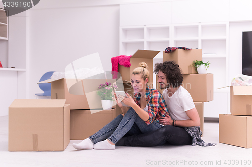 Image of young couple moving  in new house