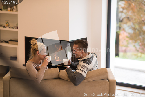 Image of Young couple  in front of fireplace