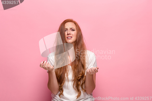 Image of The beautiful woman is offended on pink studio