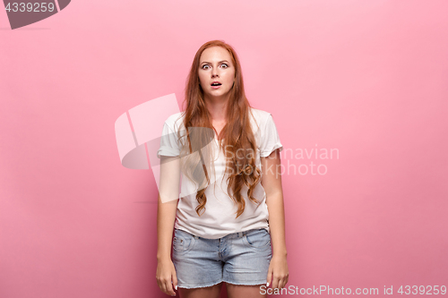 Image of Portrait of young woman with surprised facial expression