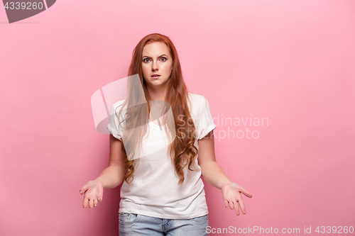 Image of The beautiful woman is offended on pink studio