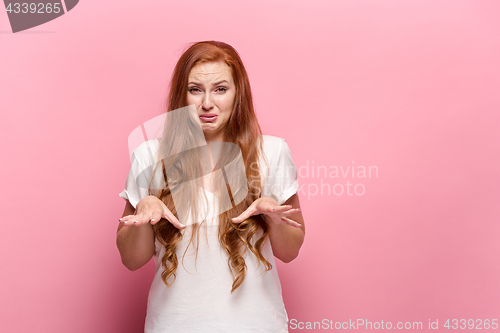 Image of The beautiful woman is offended on pink studio
