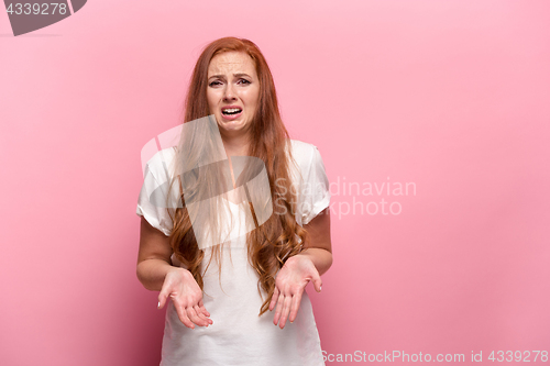 Image of The beautiful woman is offended on pink studio