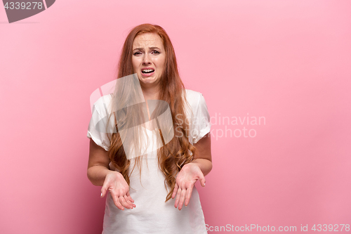 Image of The beautiful woman is offended on pink studio