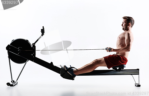 Image of Man Using A Press Machine In A Fitness Club.