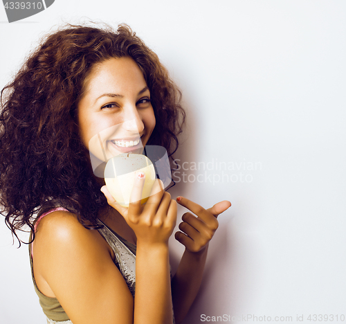 Image of pretty young real tenage girl eating apple close up smiling