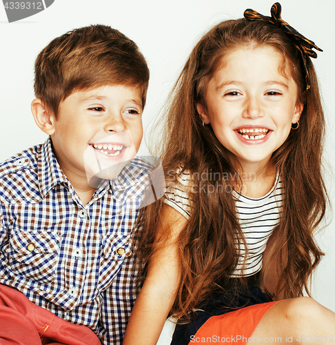 Image of little cute boy and girl hugging playing on white background, ha
