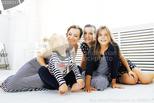 Image of Mature sisters twins at home with little daughter, happy family 