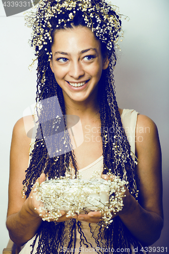 Image of young pretty brunette girl with bouquet of little white spring f