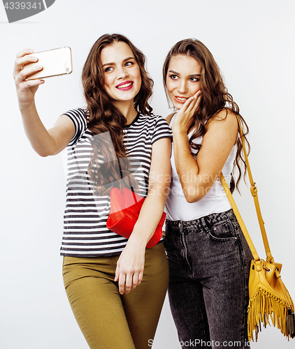 Image of best friends teenage girls together having fun, posing emotional on white background, besties happy smiling, lifestyle people concept close up. making selfie